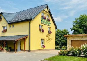 a yellow building with a sign that reads aberrant engineering at Villa Slnecnica in Nová Lesná +31 photos