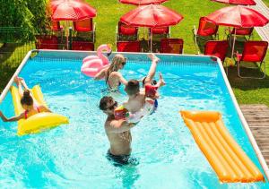 a group of people playing in a swimming pool at Holiday Park Zator in Zator +56 photos