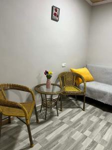 a living room with a table and chairs and a couch at Guest House Chalastavi in Godogani