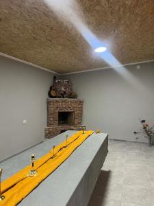a stage in a room with a brick fireplace at Guest House Chalastavi in Godogani