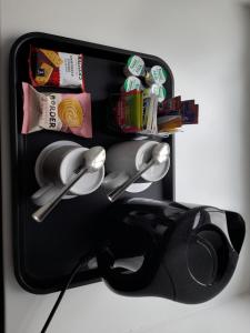 a black refrigerator with some food and other items at Adderley House B&B in Pitlochry
