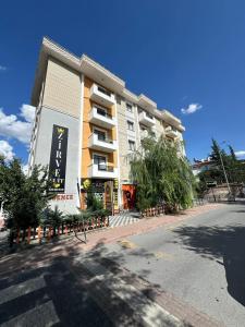 a large apartment building on the side of a street at Zirve Suit Rezidans in Talas