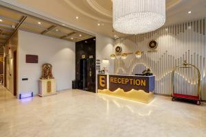 a lobby with a reception desk and a trophy on the wall at Airport Premier In With Free Airport Drop in New Delhi