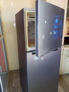 a refrigerator with its door open in a kitchen at Venusia Villa in Darou Rhamane