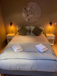 a bedroom with a bed with two towels on it at House under the Aurora Cozy Private Home with Fireplace in Laukvik