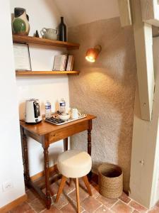 a table in a room with a coffee maker on it at La source de Vaugadeland in Nazelles