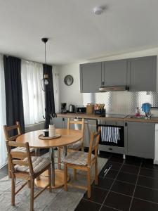 a kitchen with a table and chairs and a table and a kitchen at SchrauberStube Bertkow in Goldbeck
