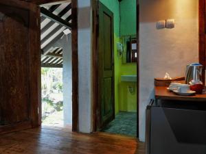 a kitchen with an open door to a room at Omahe Kancaku in Balong