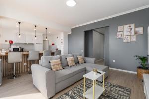 a living room with a couch and a kitchen at Casa Jorge Calaça by An Island Apart in Caniçal