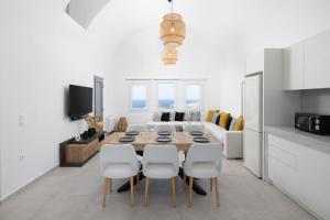 a kitchen and dining room with a table and chairs at Occhio-Nero Cycladic Private Villa with Pool & Sunset View Jacuzzi in Akrotiri