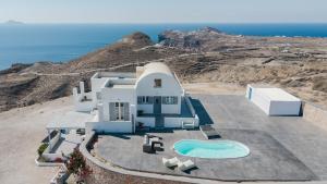 an aerial view of a house with a swimming pool at Occhio-Nero Cycladic Private Villa with Pool & Sunset View Jacuzzi in Akrotiri