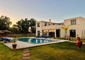 a house with a swimming pool in the yard at Dar Ayman Essaouira in Essaouira
