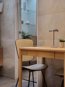 a room with a wooden table and a chair at Le Clos des Champis in Scorbé-Clairvaux +75 photos