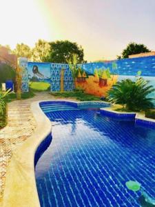 a large blue swimming pool in front of a building at Venusia Villa in Darou Rhamane