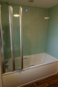a shower with a glass door in a bathroom at Taftnica in Burray Village +8 photos