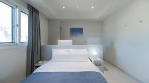a bedroom with a bed and a large window at The M Hotel in Seoul