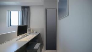 an office with a desk with a computer on it at The M Hotel in Seoul