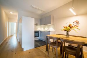 a kitchen and dining room with a table and chairs at Apartment Harderstrasse in Interlaken