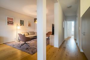 a living room with a couch and a table at Apartment Harderstrasse in Interlaken +3 photos