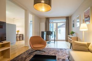 a living room with a couch and a chair at Apartment Harderstrasse in Interlaken