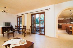 a living room with a table and a dining room at Sarris Villa in Áyios Mámas