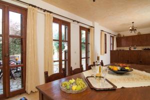 a kitchen with a table with a bowl of fruit on it at Sarris Villa in Áyios Mámas