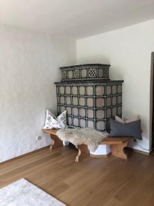 a room with a black dresser and a wooden bench at Bergblick Kampenwand in Aschau im Chiemgau
