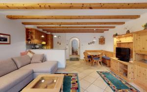 a living room with a couch and a table at Champagna in Celerina