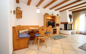 a kitchen with a table and chairs in a room at Champagna in Celerina