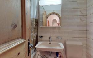 a bathroom with a sink and a toilet and a mirror at Champagna in Celerina