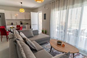 a living room with a couch and a table at Symphony Suite in Panormos Rethymno