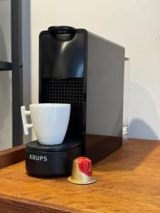 a coffee maker with a cup on a table at Studio Biarritz Côte des Basques in Biarritz +14 photos