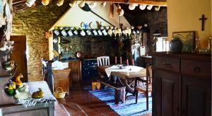 a kitchen with a table and a dining room at Casa de Fujacos in Valença