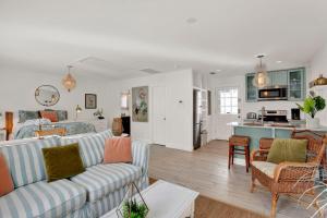 a living room with two couches and a kitchen at Crawford Carriage House in Savannah