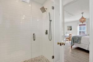 a white bathroom with a shower and a bedroom at Crawford Carriage House in Savannah +16 photos