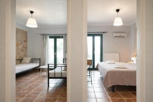 a bedroom with a bed and a living room at villa Fotini 2 (new) in Syvota