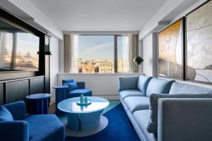 a living room with a couch and chairs and a table at Sea Containers London in London
