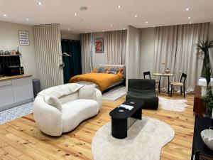 a living room with a couch and a bed in a room at STUNNING Apartments in Jarrow, next to A19 & Tyne Tunnel in East Howdon