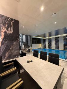 a dining room with a table and a swimming pool at Fidji Hotel in Yerevan