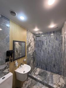 a bathroom with a sink and a toilet and a tub at Fidji Hotel in Yerevan +74 photos