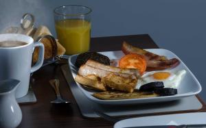 a plate of breakfast food and a cup of coffee at Adderley House B&B in Pitlochry +8 photos