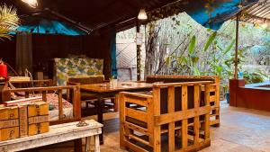 a dining room with a table and chairs at GoArize by Rootsvilla Vagator in Anjuna