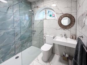 a bathroom with a toilet and a sink and a shower at Hilston Park in Monmouth +62 photos