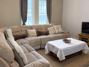 a living room with a couch and a table at Hilston Park in Monmouth
