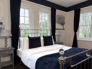 a bedroom with a large bed and windows at Hilston Park in Monmouth