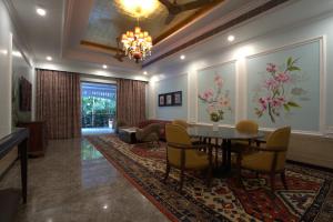 a living room with a table and chairs at Mayfair Oasis Resort & Convention in Jhārsuguda