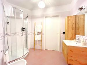 a bathroom with a shower and a toilet and a sink at Aura Suites Napoli in Naples