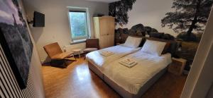 a bedroom with a bed with a rock wall at Herberg De Eexter Os in Eext