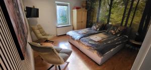 a bedroom with a bed and a chair in it at Herberg De Eexter Os in Eext
