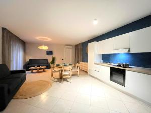 a kitchen and living room with a couch and a table at Aura Suites Napoli in Naples +41 photos